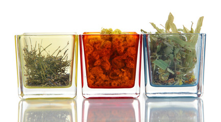 Dried herbs in glass containers isolated on white