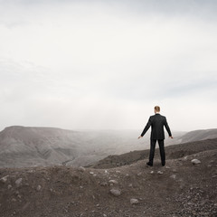 businessman standing alone in the desert