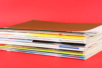 Many magazines on red background