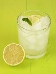 Lemonade in glass on wooden table close-up