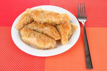 Sweet baklava on plate on table