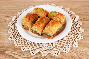 Sweet baklava on plate on table