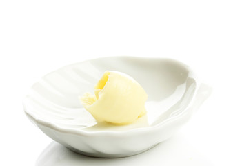 Butter curl on plate, isolated on white