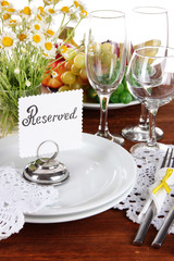 Table setting with chamomiles on wooden table close-up