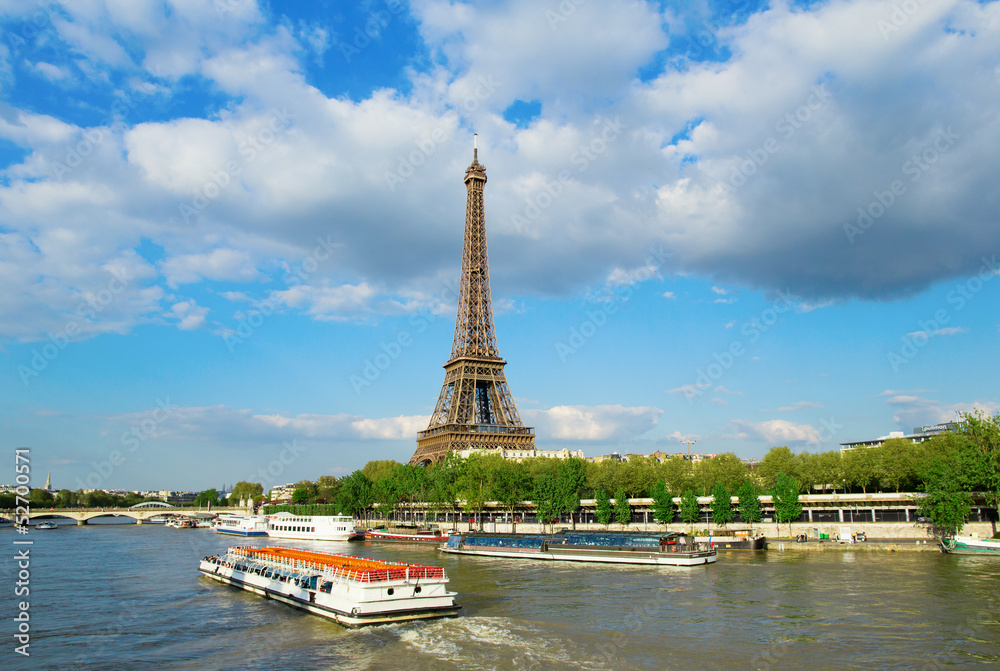 Wall mural eiffel tower with touristic boat on seine