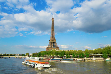 Eiffel tower with touristic boat on Seine