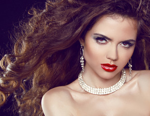 Fashion portrait of sexy woman. Red Lips. Beauty and Jewelry.