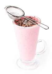 Fresh strawberry milkshake in a glass powdered with chocolate, o
