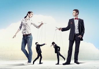 Businesspeople with marionettes