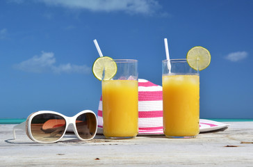 Sunglasses, hat and orange juice