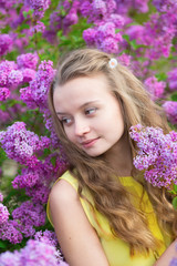 Girl with beautiful blooming lilac
