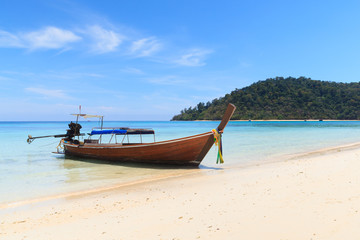 Boat on the beach with blue sky