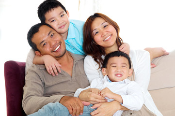 Portrait of asian family sitting on sofa