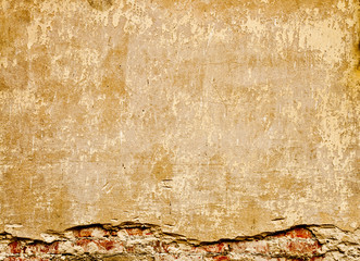 Brown old wall with plaster and bricks