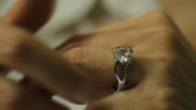 Divorce, a woman hand take off a diamond ring from the finger