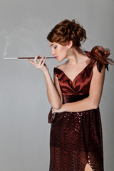 Retro glamor portrait of beautiful woman smoking cigarette