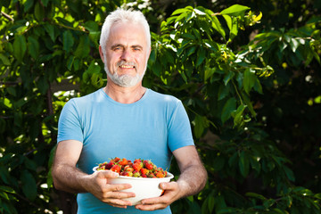 senior man with strawberry