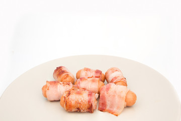 Bacon ham sausage on dish isolated on white