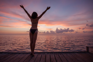 Caucasian woman practicing yoga at seashore