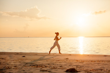 Fototapeta na wymiar Caucasian woman jogging at seashore