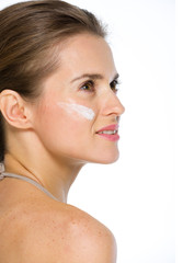Obraz premium Beauty portrait of young woman with creme on cheek