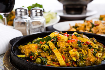 Fried fish with fresh herbs and  spicy sauce served on iron hot