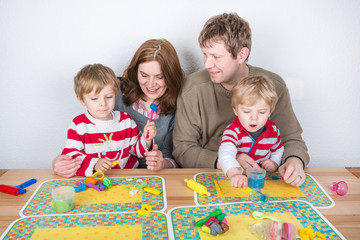 Fototapeta premium Happy family of a four having fun at home