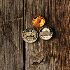 US cent coins over wooden background