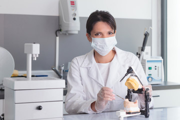 Fototapeta na wymiar Young woman doctor working in dental prosthesis