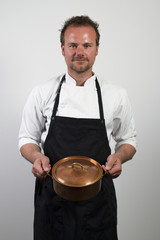 chef holding copper pan