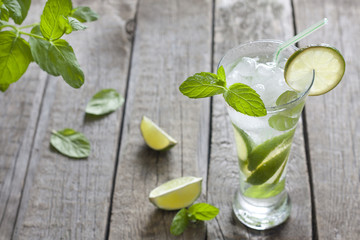 Cocktail Mojito on vintage wooden table in restaurant