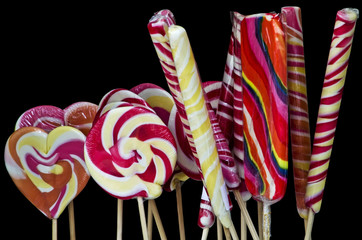 Multicolored lollipops isolated over black