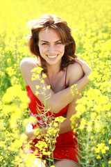 Naklejka na ściany i meble Happy girl enjoying the nature on a sunny day in the flowering