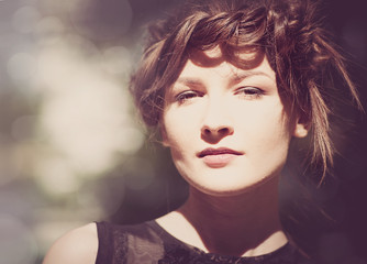 Lite sepia colorized vintage female portrait with beauty bokeh