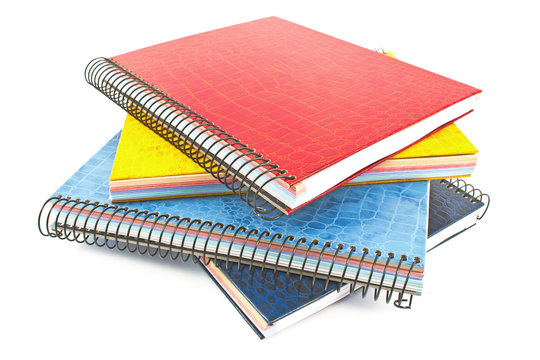 Stack of colorful spiral notebooks