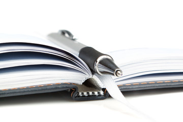 Notebook office organizer and fashionable ballpoint pen close-up