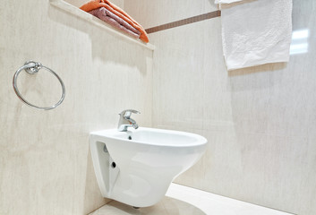 Modern bathroom with white ceramic bidets. Close-up.