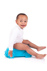 African child on potty, isolated over white