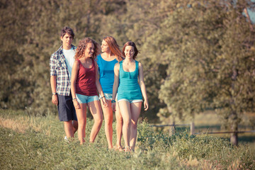 Fototapeta premium Group of Teenage Friends Walking at Park