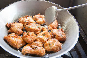 Frying corn meal mush in hot oil in an iron pan