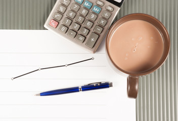 Close-up image of an office desk at morning with a cup of tea an
