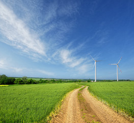 wind turbines on a beautiful spring field