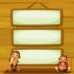 Two musical monkeys in front of the hanging signboards