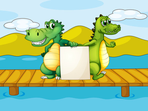 Two crocodiles holding an empty board