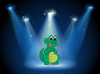 A young crocodile at the stage with spotlights