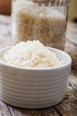rice in bowl on wooden background
