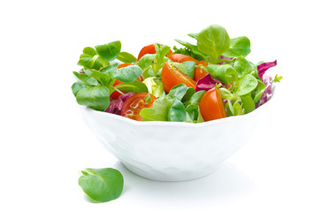 bowl of fresh salad and cherry tomatoes isolated on white
