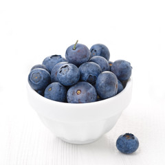 bowl with fresh blueberries on a white background close-up