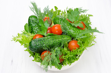 Obraz na płótnie Canvas bowl with fresh vegetables and herbs for salad horizontal