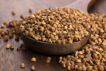 Buckwheat seeds on wooden spoon in closeup